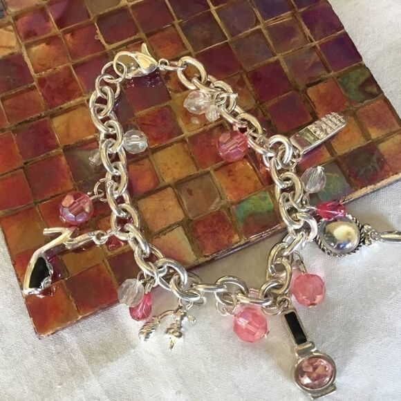 $12 ea of 3/$25. Silvertone “Girly” Charm Bracelet - Picture 1 of 7